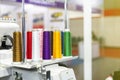 Many colorful cotton reel thread set up at modern and automatic high technology sewing or embroidery machine for textile Ã¢â¬â Royalty Free Stock Photo